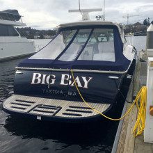 A boat docked at a dock with the word big bay on it.