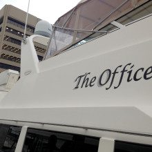 A white boat with the word office on it.