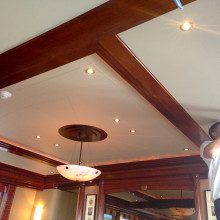 A man is working on a ceiling in a restaurant.
