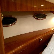 A boat with a bed and a bedside table.