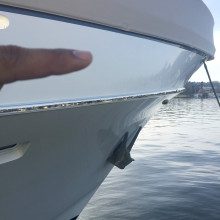 A person is pointing at the end of a boat.