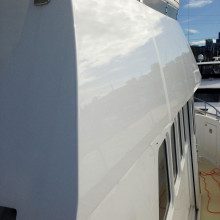 The back of a boat with a white paint job.