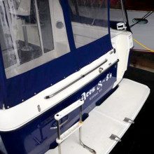 A blue and white boat is parked in a garage.
