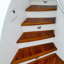 The stairs on a boat are made of wood.