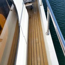 The deck of a boat with a wooden floor.
